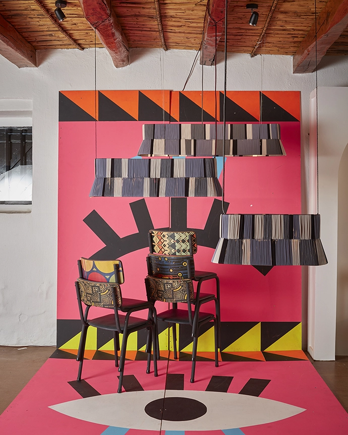Woven lights by Siviwe Jali above chairs by Naturalis, with patterns by Nando’s HYD finalists on display at Clout/SA and Nando’s HYD showcase at Spier. Curated by Tracy Lynch, creative director Clout/SA