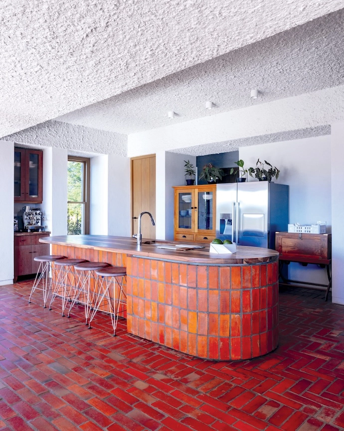 The kitchen is filled with standalone antique cupboards that the owners have collected over the years. The walls and ceilings throughout the home are either textured, with a stipple plaster render; or a smoother wood trowel, finished with a sandy admixture paint.