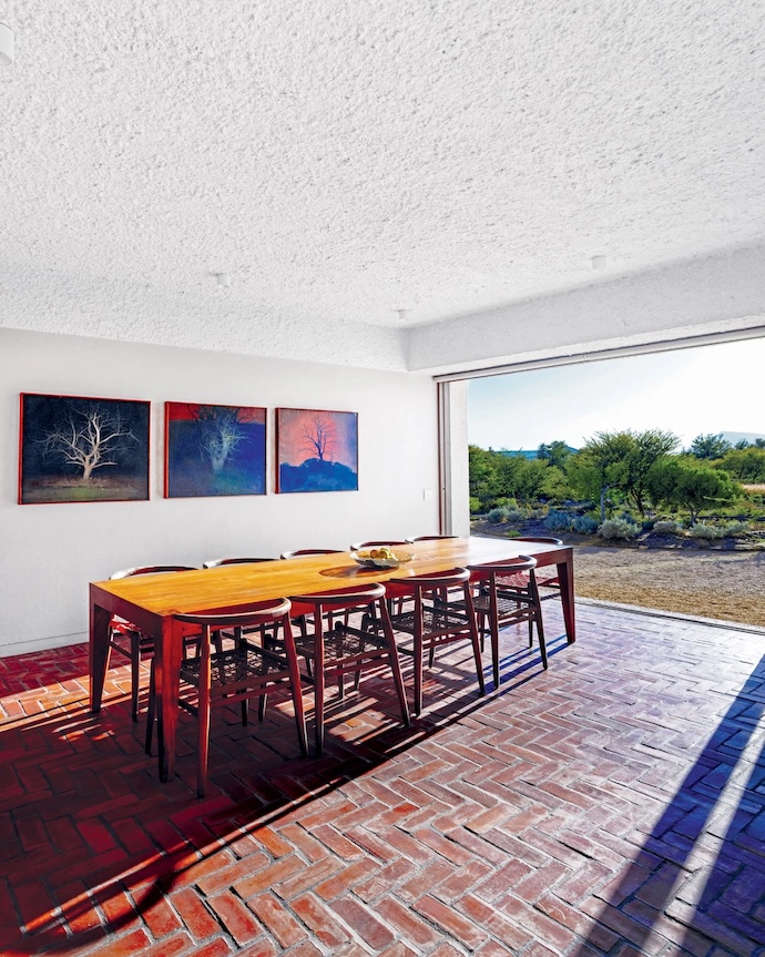 The dining table is by Pierre Cronje and the West Elm chairs are by John Vogel. Trees are a strong theme in the art that owner Wilhelm Boshoff collects – and these three paintings, by Czech artist Tomáš Honz, were a gift from a friend. 