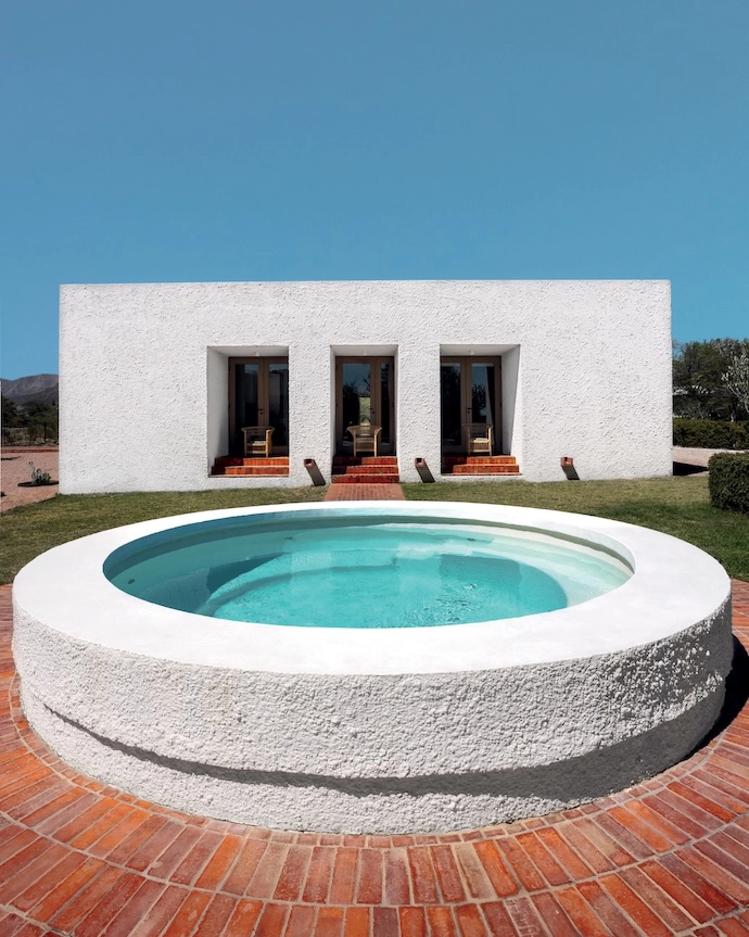 The farm-style pool is situated between the cottage and the main house. 