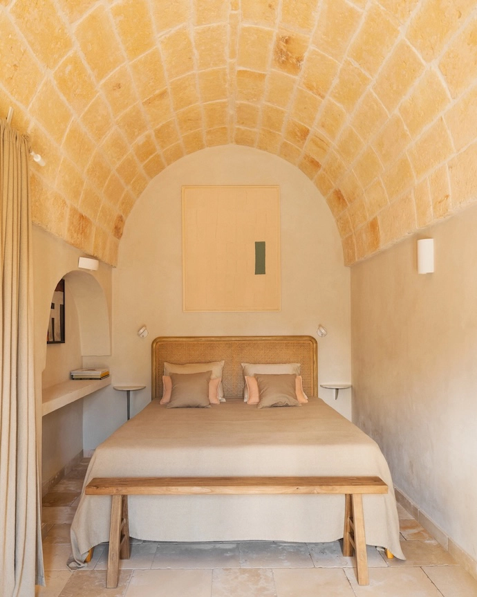 The bedroom in the small villa is the only original room on the property and features an arched stone ceiling.