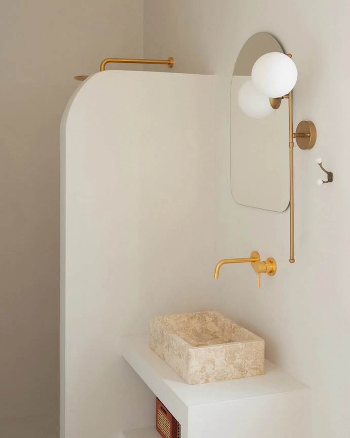 The bathroom is finished in neutral tones and textures.