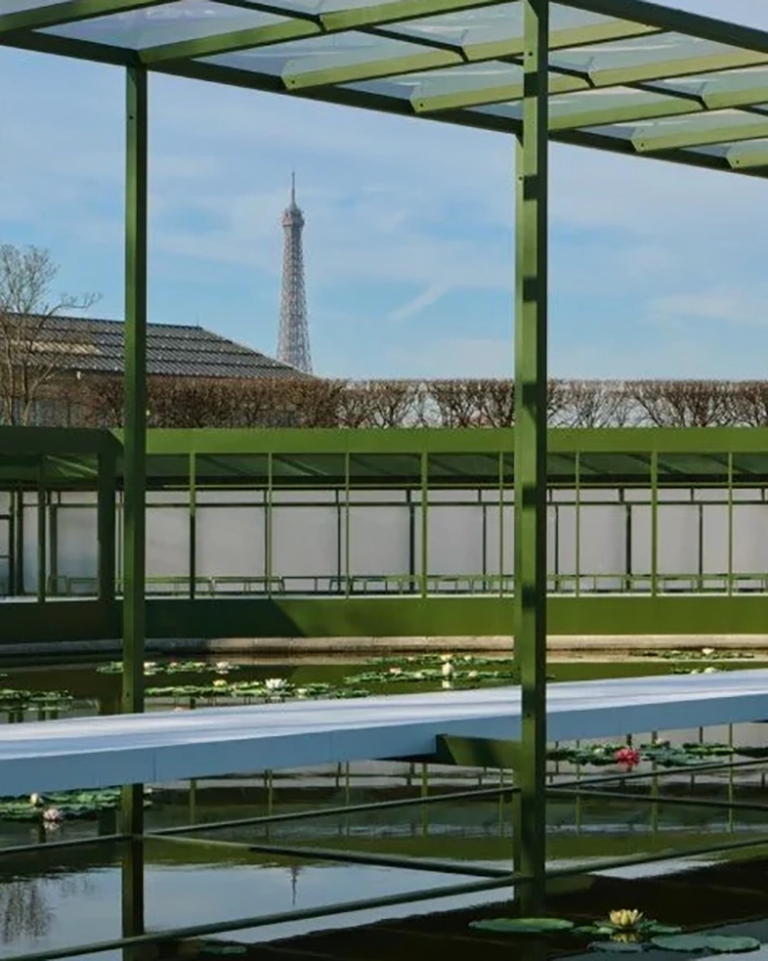 Artificial water lilies placed on the surface of the pond, creating a dreamlike landscape.