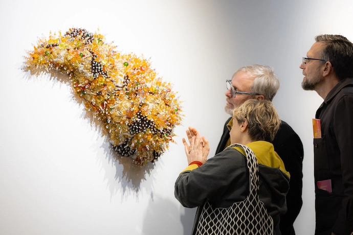 On opening night of HEAT Winter Arts Festival last year two viewers study the work of Salah Davids, which showed at Ecletica Contemporary.