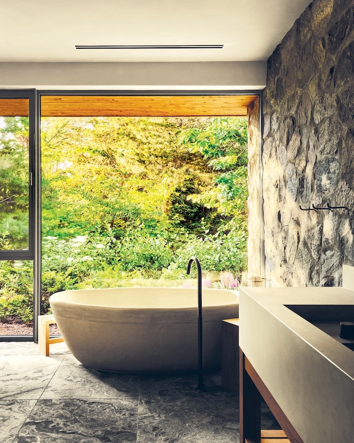 “In the en suite bathroom, a stone double basin and ceramic tub create a tranquil setting,” says Adam.