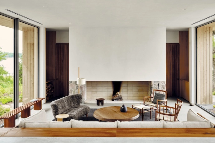 “Framed by a bespoke sofa on one side and a fieldstone hearth on the other, the living space was envisioned as a calm place to gather, play and entertain by the warmth of the fire,” says Adam. The woven seats of two armchairs and the sheepskin upholstery of &Tradition’s Little Petra VB2 lounge chair add textural interest.