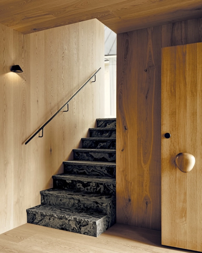 “Guests are welcomed by a pebble-shaped door handle and led into a gently lit oak-lined entryway,” says Adam.