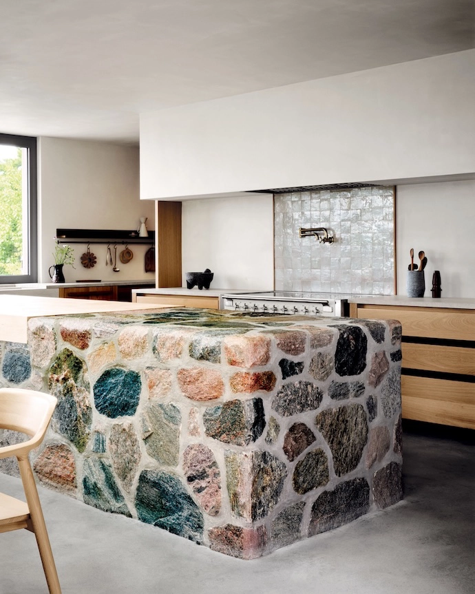 Built from local fieldstone, the kitchen island is reminiscent of rugged picnic tables, and includes a maple butcher block.