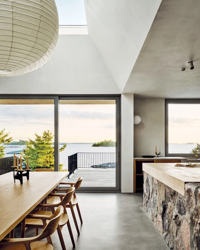 Glass doors, windows and an oversized light well flood the living space with ever-changing light.