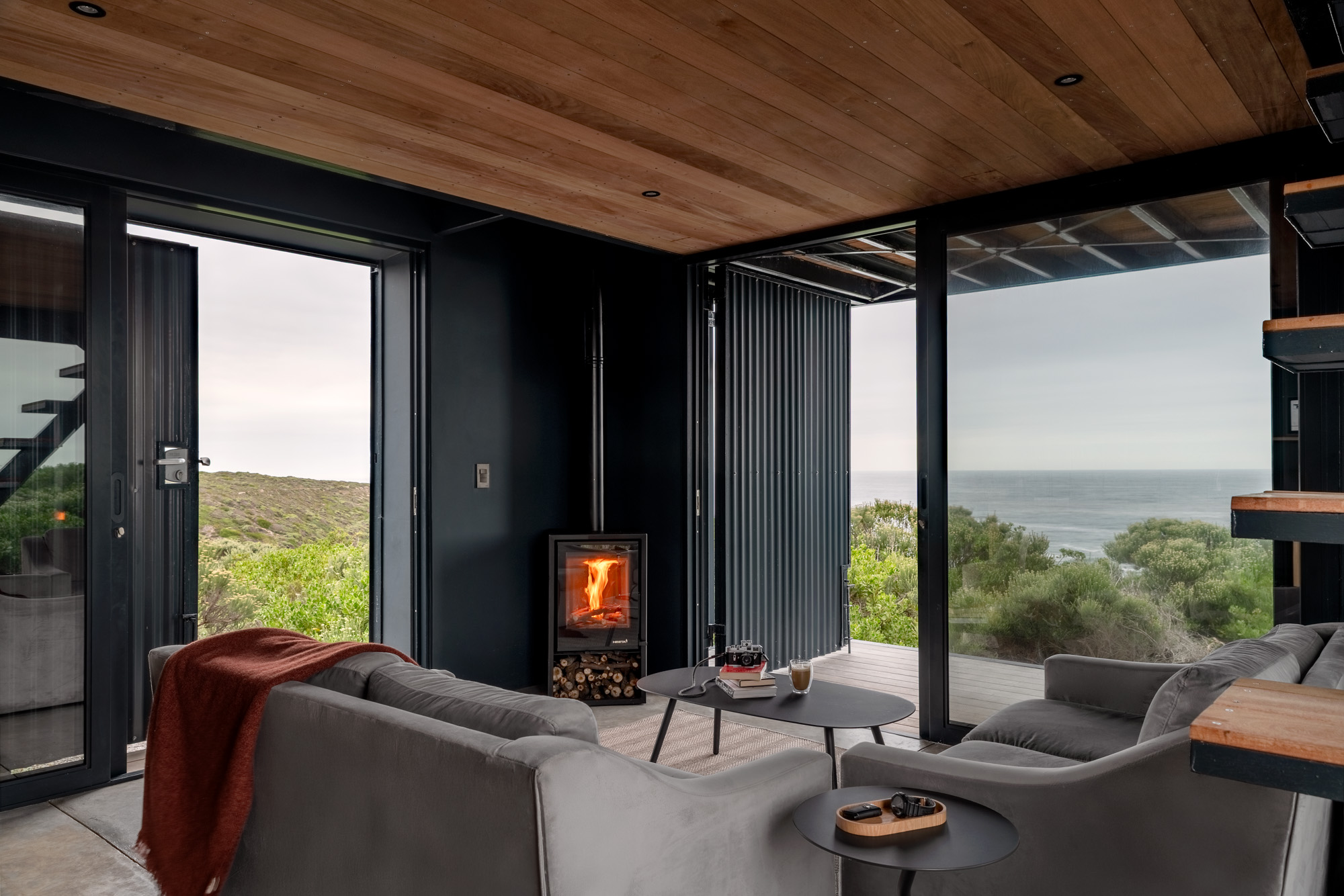 The open-plan living area is warm and cosy in winter thanks to a wood-burning stove, and bright and breezy in summer thanks to the south- and east-facing sliding doors that encourage cross-ventilation.