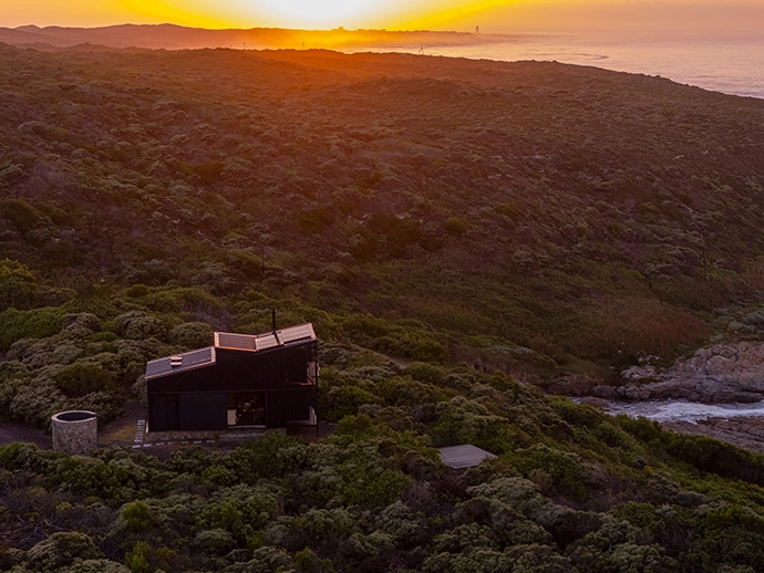 A bird’s-eye view of the cabin, and the cylindrical storage area clad in stone excavated on the farm.
