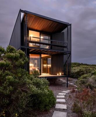 This prefabricated steel cabin on a remote farm near Cape St Francis is oriented around the ocean view – best appreciated from the loft bedroom and living room patios, where the cantilevered structure makes the occupants feel as though they’re floating above the expanse.