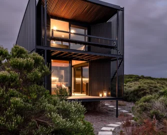 This prefabricated steel cabin on a remote farm near Cape St Francis is oriented around the ocean view – best appreciated from the loft bedroom and living room patios, where the cantilevered structure makes the occupants feel as though they’re floating above the expanse.