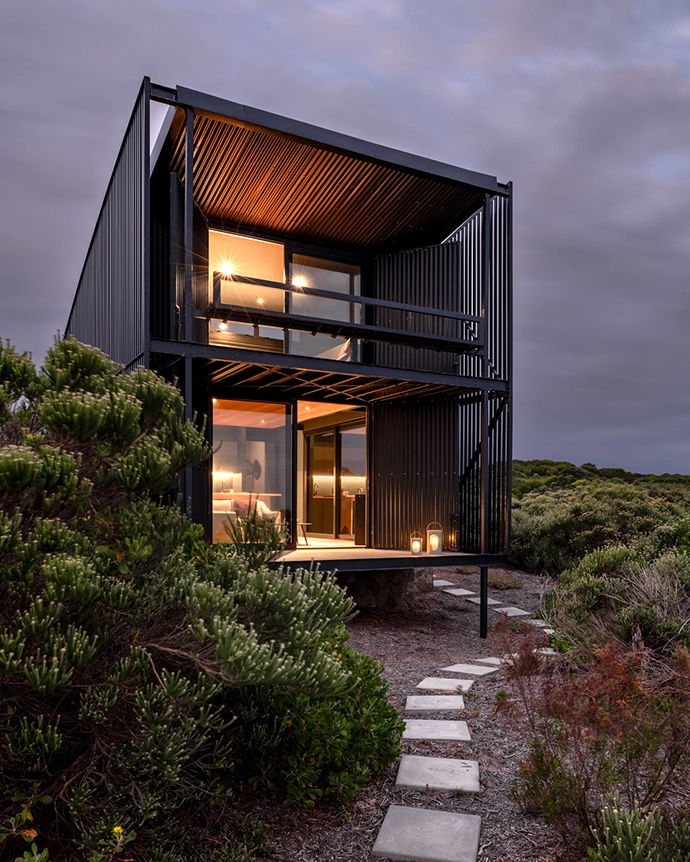 This prefabricated steel cabin on a remote farm near Cape St Francis is oriented around the ocean view – best appreciated from the loft bedroom and living room patios, where the cantilevered structure makes the occupants feel as though they’re floating above the expanse.