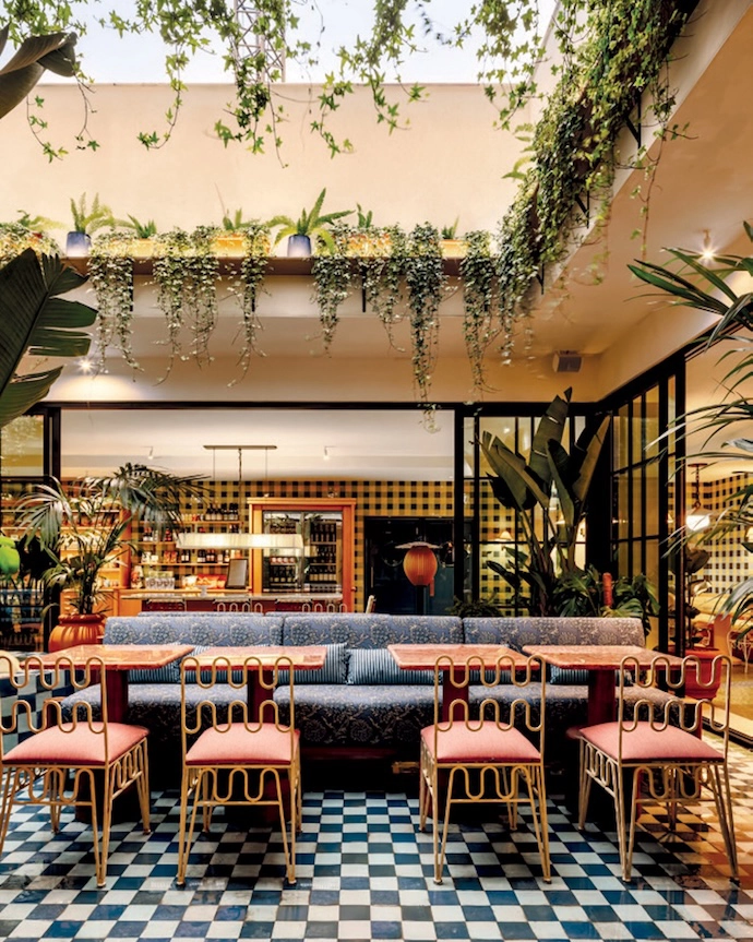The interiors of Wilde Lisbon in Portugal prove that texture is king. At the heart of the hotel, the bar and lounge feature marble, plush seating, tastefully gathered curtains, and an abundance of colour. Traditional touches are playfully subverted and iconic tile patterns reimagined – for example in the interior courtyard, where blue chequered floors are paired with wood furniture.