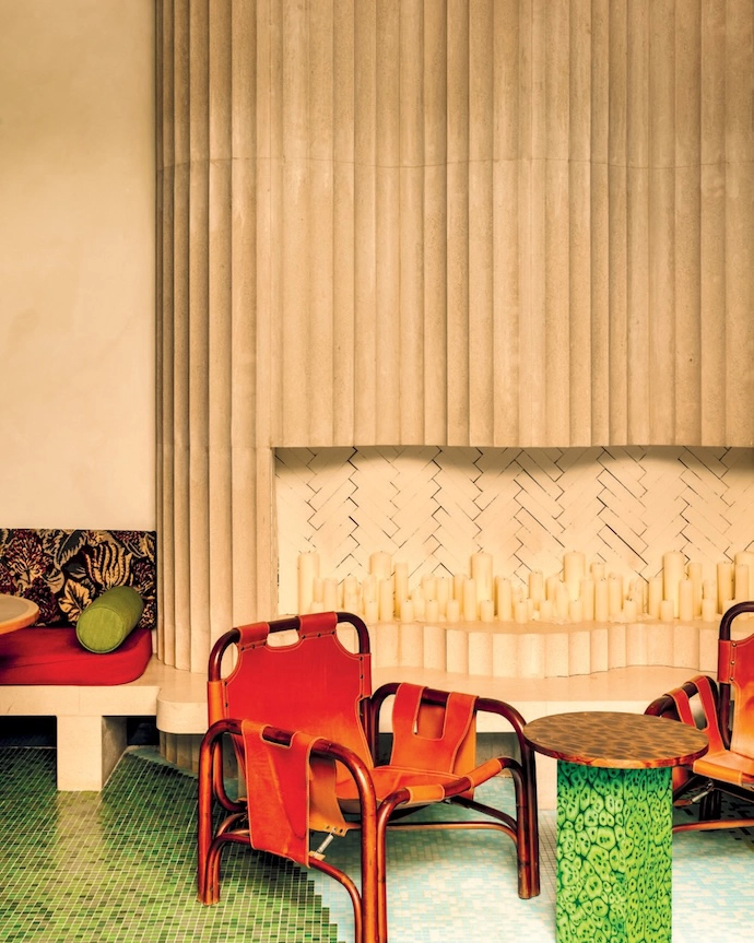 The interiors of Wilde Lisbon in Portugal prove that texture is king. At the heart of the hotel, the bar and lounge feature marble, plush seating, tastefully gathered curtains, and an abundance of colour. Traditional touches are playfully subverted and iconic tile patterns reimagined – for example in the interior courtyard, where blue chequered floors are paired with wood furniture.