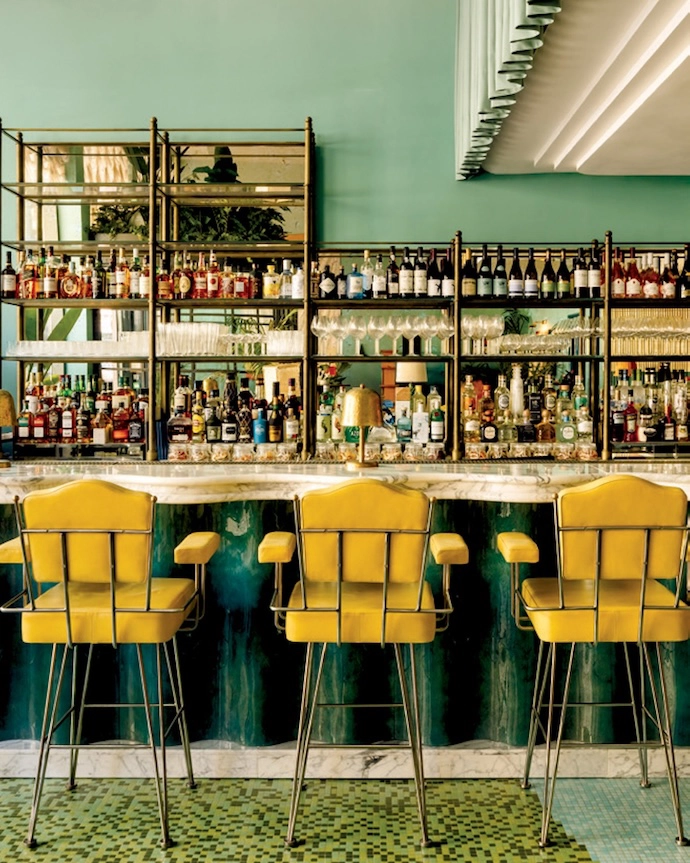 The interiors of Wilde Lisbon in Portugal prove that texture is king. At the heart of the hotel, the bar and lounge feature marble, plush seating, tastefully gathered curtains, and an abundance of colour. Traditional touches are playfully subverted and iconic tile patterns reimagined – for example in the interior courtyard, where blue chequered floors are paired with wood furniture.