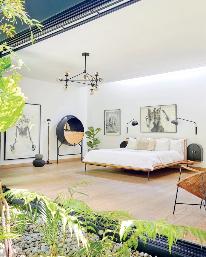 The spacious main bedroom is centred on the platform bed, with integrated bedside tables custom-designed by Erica. Extra storage comes courtesy of a repurposed drinks cabinet by Joe Paine, and the wooden flooring is by Finfloor.