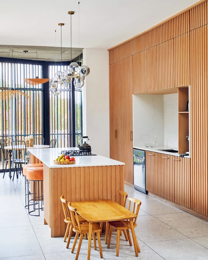 In the kitchen, the kids’ dining table and chairs are by Houtlander, and the stools were found at a local decor store some years back. The gas hob is by Smeg; the lights over the island are from Elevenpast.
