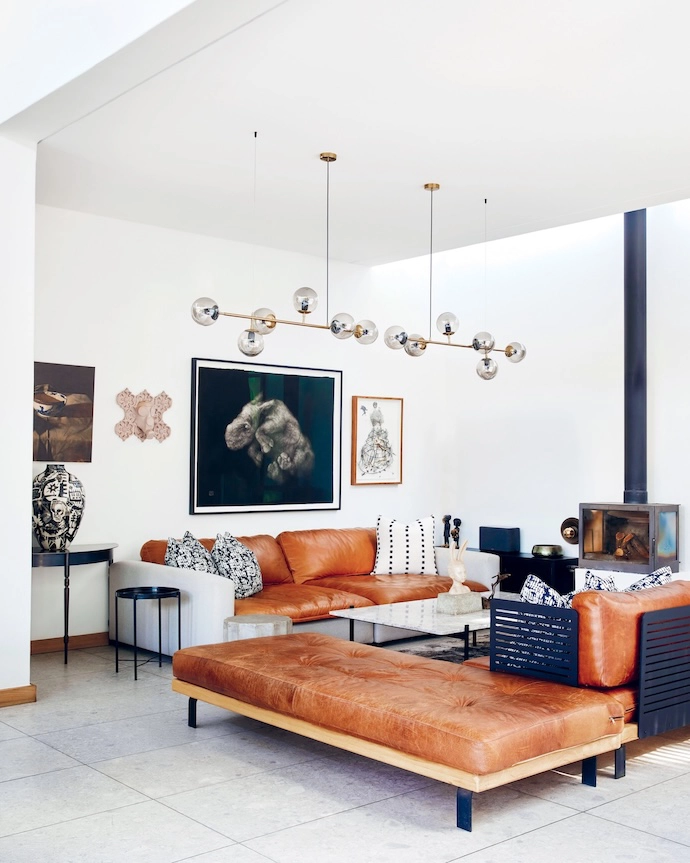 The indoor lounge showcases Erica’s deft touch with mixing multiple textures. The leather and textile couch was custom-designed by her; the box couch opposite it and the daybed are by Goet Furniture and Design. The coffee table is from Lemon and the pendant lights are from Elevenpast.