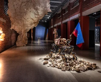 View of Reverse Futures exhibition showing Paula Gaetano Adi, Guanaquerx (2024) in the foreground, and Georgia Munnik, The Strangling Fruit (2026) at left; with Cave_bureau’s installation Shimoni Slave Cave (2022–2023) in the background.