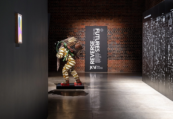 View of Reverse Futures exhibition, from left Etel Adnan, Satellites 27
(2020); Yinka Shonibare, Refugee Astronaut X (2024) and Calculating
Empires: A Genealogy of Technology and Power since 1500 (2023) by
Kate Crawford and Vladan Joler.