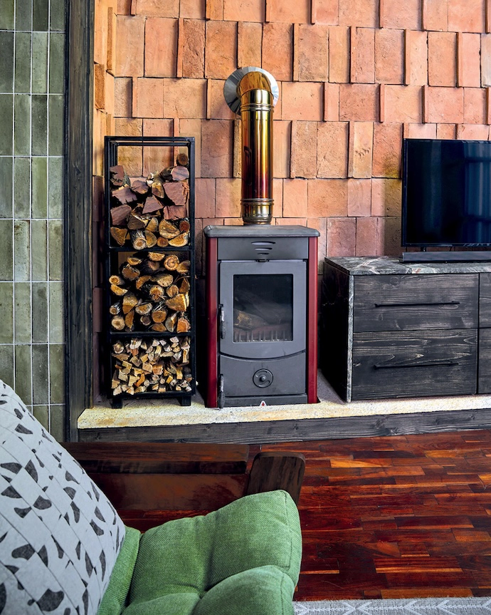Jonty rebuilt the base of the original fireplace in thick stone offcuts to give it a cleaner, more grounded presence.