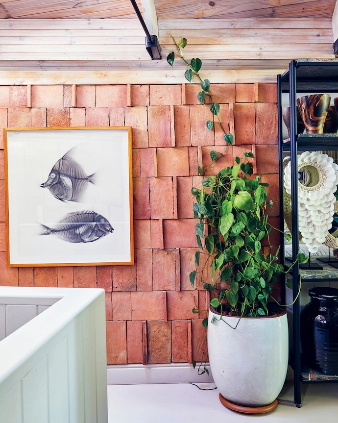 At the top of the stairs, the palette softens into pale tones and lighter timber.