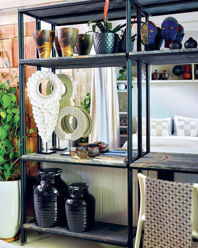 A divider separates the sleeping area from a small workspace without interrupting airflow or light.