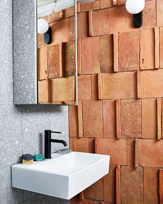 The terracotta tile carries through into the bathroom.