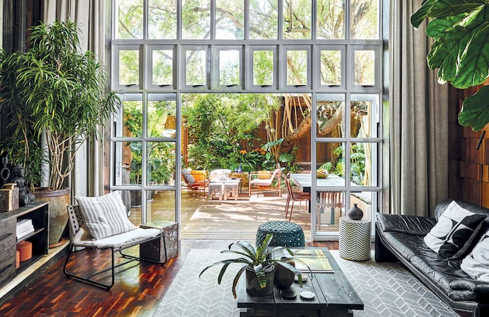 The courtyard becomes a living backdrop to the interior, framed by the full-height glazing.