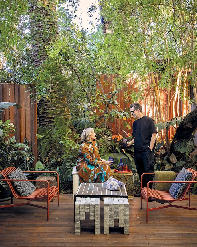 Owners Jonty and Lee-Ann Olmesdahl outside, where the materials of the house meet the greenery of the courtyard.