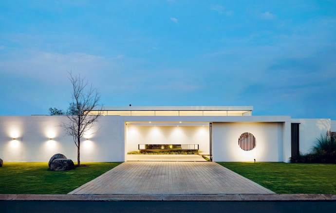 A strategically positioned porthole offers passers-by a glimpse beyond the understated street facade.