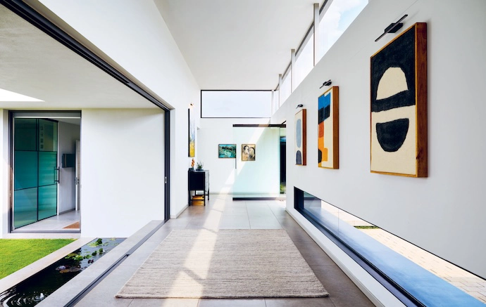 Generous volume is created in the arrival gallery with tall, street-facing clerestory glazing.