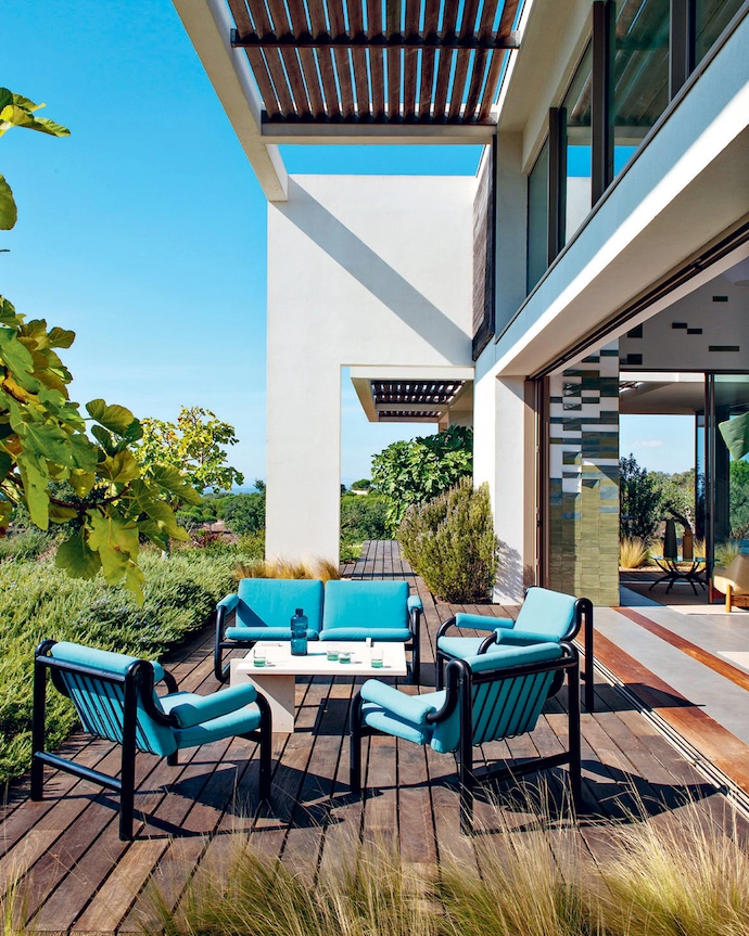 The terrace off the living room features a furniture set by Geraldo de Barros and a coffee table in Moleanos limestone from Christophe’s Alma de Comporta collection.