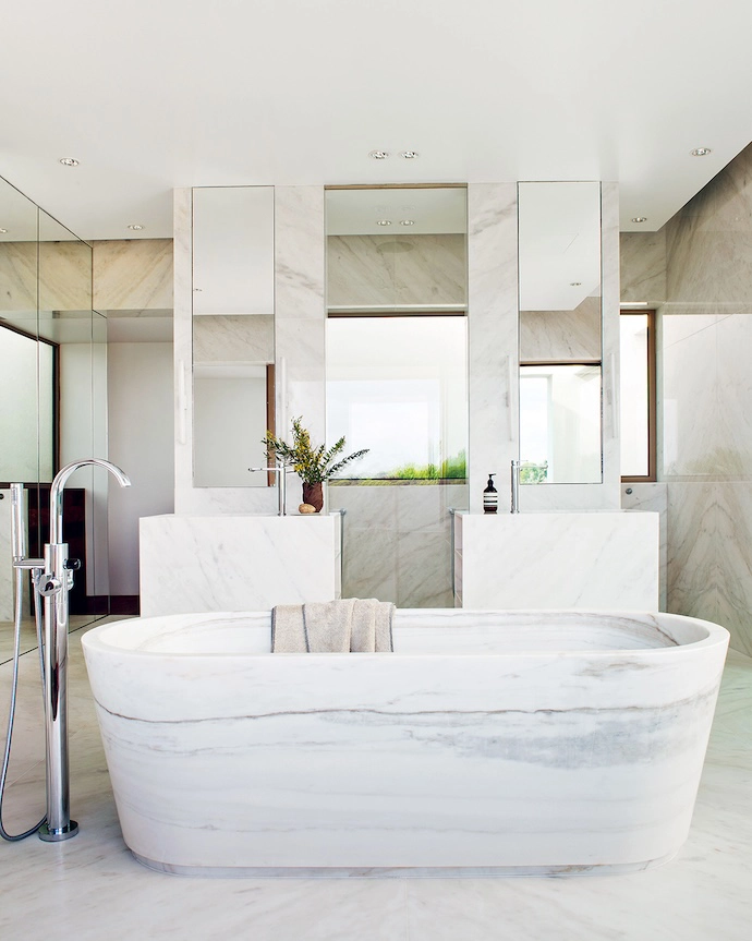The main en suite bathroom, which has views towards the ocean, is clad entirely in Estremoz marble.