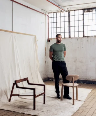 Tom Lead with his Studio chair (left ) and Koppie chair (right). The latter – a collab with Stripped Collective – was the winner of the Cape Town Furniture Week x VISI Design Prize.