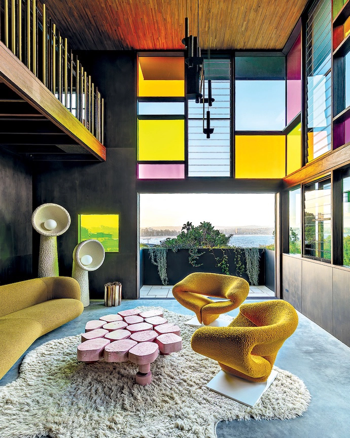 “The stained glass windows are such a bold move, especially in a house with incredible views – most homeowners wouldn’t want to obstruct them,” says interior designer Jase Sullivan. The colour palette is reinforced by the inclusion of two 1960s Pierre Paulin Ribbon chairs and a pink DenHolm coﬀee table.