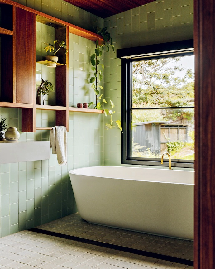 A serene bathroom reflects the colours in the garden beyond.