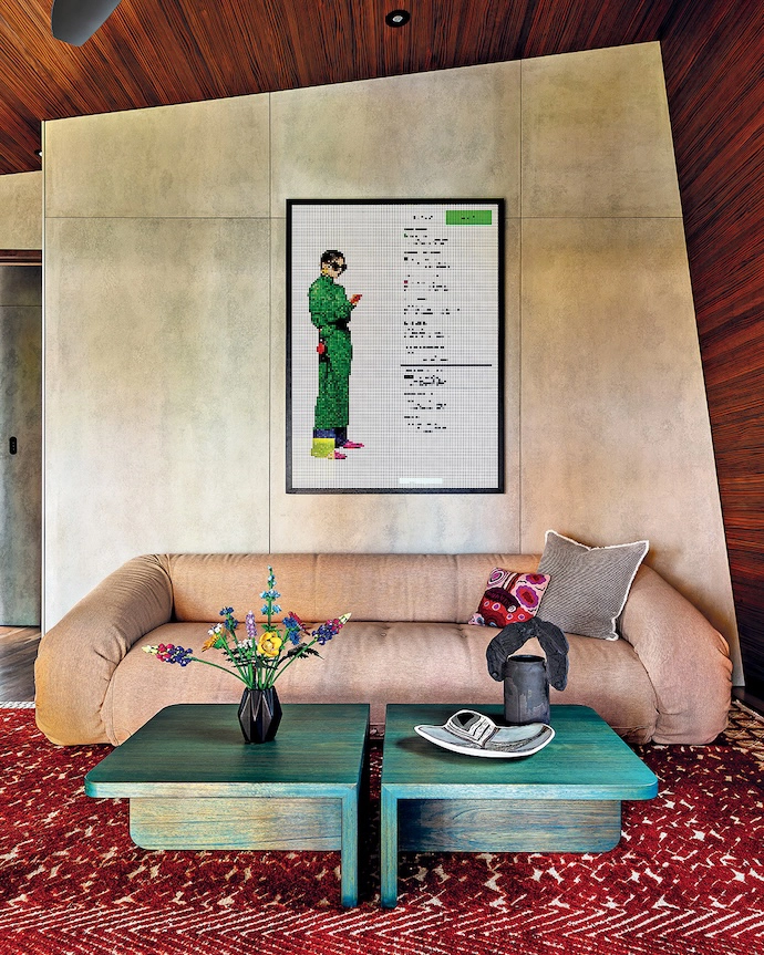 A bespoke table by Jase and a 1970s folding Anfi bio sofa by Alessandro Becchi anchor an artwork in this boldly coloured living space.