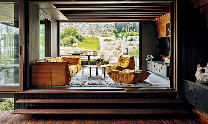 Across the deck from the kitchen, a playroom – with iconic Togo seating – offers easy access to the back garden and pool.