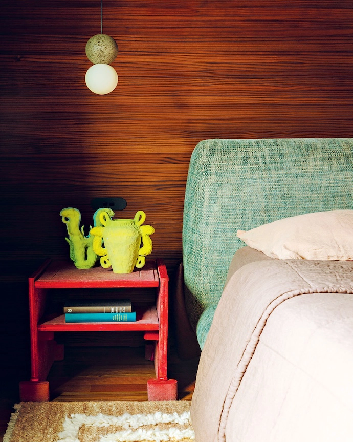 In the main bedroom, Jase offset an upcycled headboard with a David Pompa pendant lamp and bedside table by DenHolm.