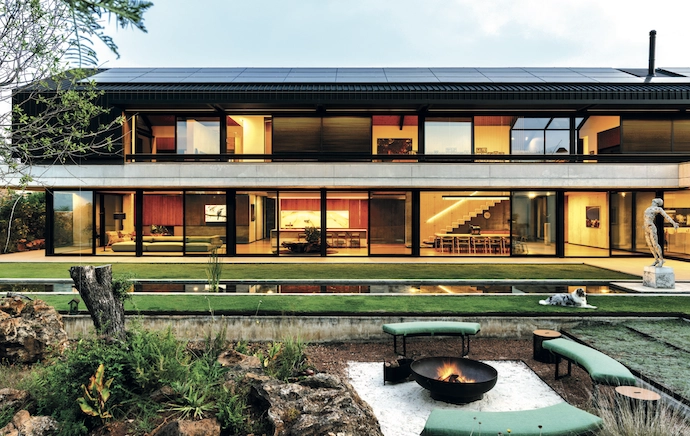 Viewed from a field of grass; viewed from the garden, it appears as a double-storey building, with large glazed facades creating openness and transparency where the entrance ensures privacy.
