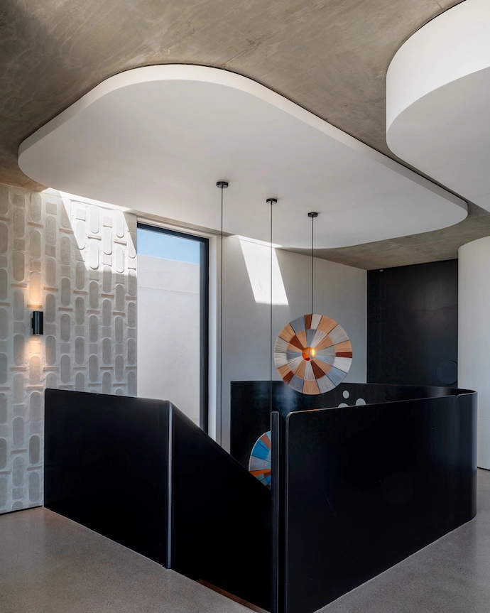 Another variation of the tile pattern adorns a feature wall at the top of the stairs.