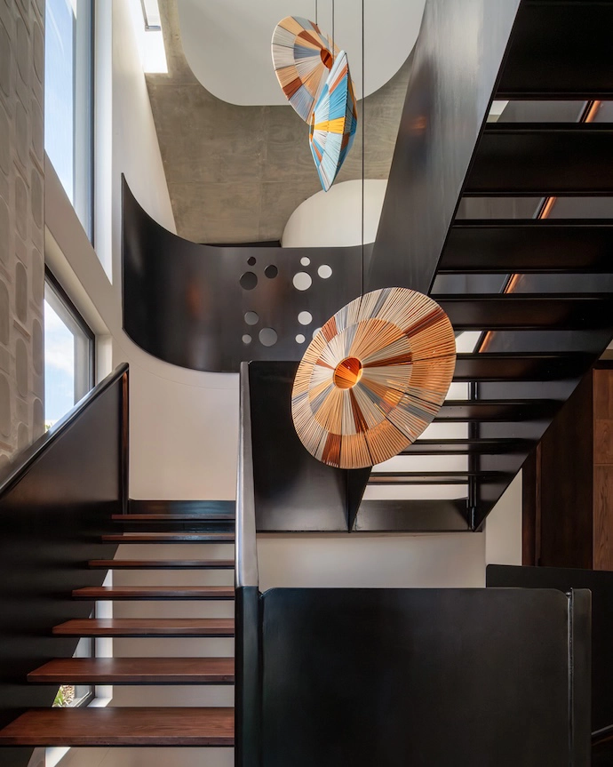 Natural light pours into the stairwell from above.
