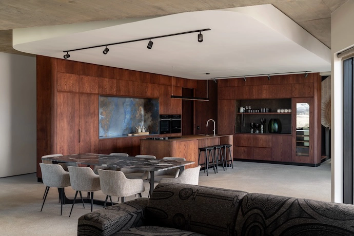 The kitchen cabinetry takes on the function of walls and room dividers, defining the space but also extending the function of architecture into the furnishings.