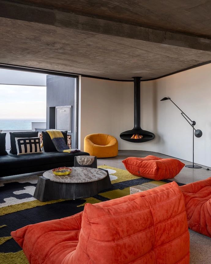 In the main living room, a classic Togo suite by Ligne Roset holds pride of place among local handcraft ed items, including textiles by Frances van Hasselt and carpets by The Ninevites.