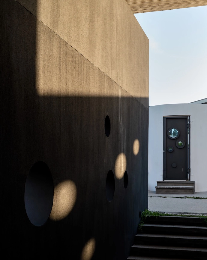 Repeated circular motifs create portholes and lens-like frames for views.